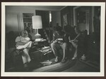 F.A.R.I.N.E Group Looking at Photos Inside Living Room by Franco-American Programs, Orono, ME
