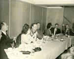 Charley Miller with Friends at a Banquet Table